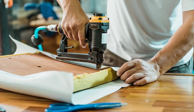 man with stapler upholstery gun