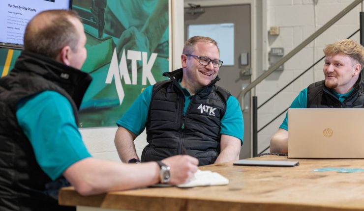 Three MTK Group colleagues engaged in conversation
